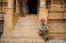 a man sitting on steps in India 