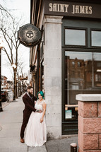 bride and groom on a downtown sidewalk 
