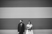 bride and groom standing outdoors 