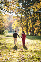 engaged couple walking holding hands 