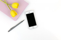 cellphone, iPhone, yellow, tulips, spring, journal, notebook, white background, pen, desk 