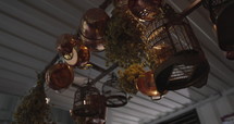 Trendy house with bird cages and strainers hanging from ceiling - decoration