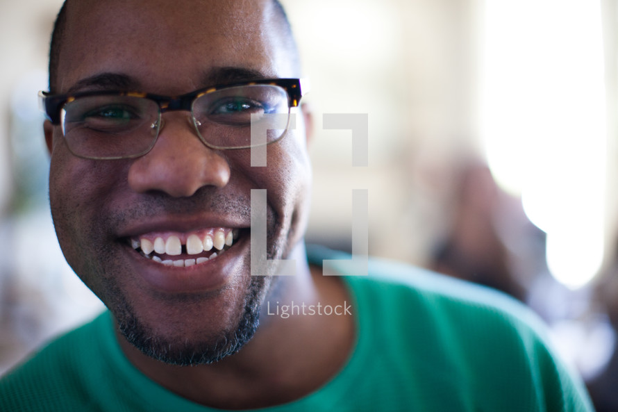 face of a smiling man at a small group gathering 