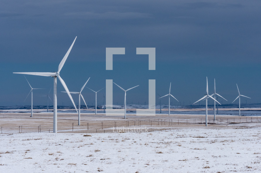 Wind Turbines with Rocky Mountains in the Winter