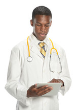 Young man in a doctor's white coat and a stethoscope around his neck, looking at a medial chart