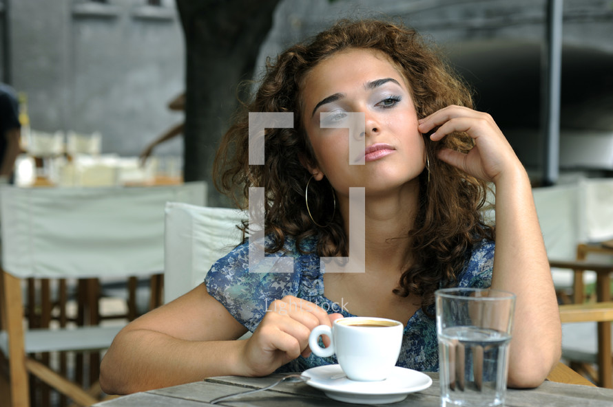 a young woman drinking coffee thinking 