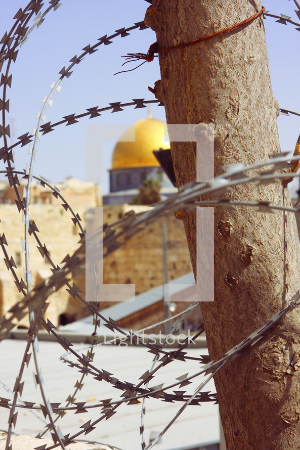 dome of the rock behind barb wire