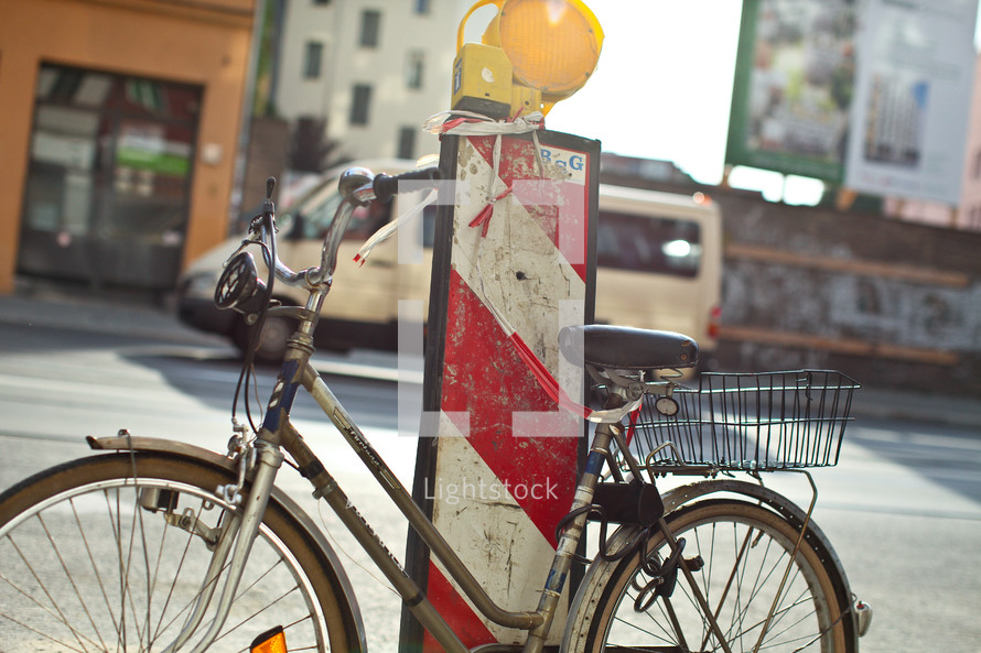 A bicycle rests next to a roadwork pylon in Berlin 