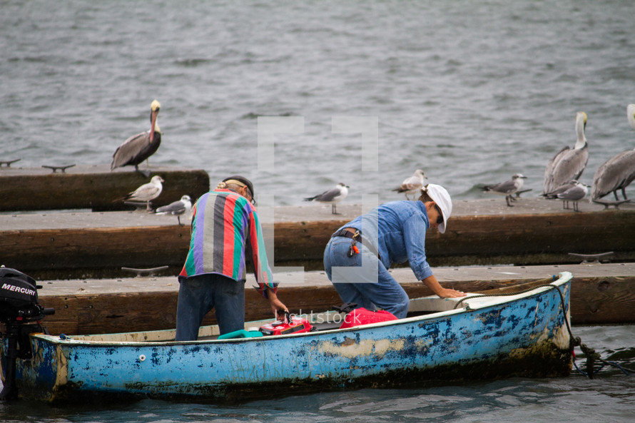 pelicans and fishermen on a boat 