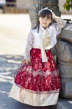 A little girl in a traditional Korean princess dress