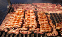 Grilled meat on a hot grill. Specialty meat sold as street food.