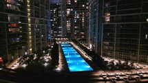 Tracking Shot of Downtown Miami Nightlife Pool and City Buildings