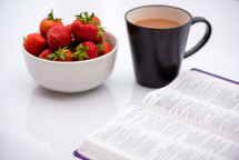 strawberries, coffee mug, and open Bible 