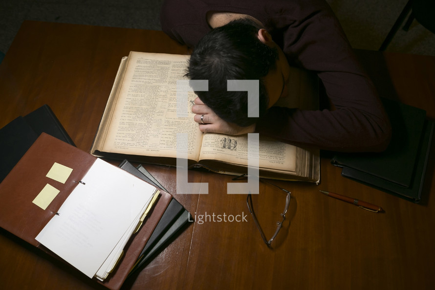 a man tired after reading books 