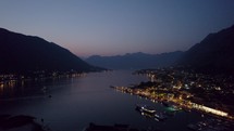 Night aerial drone of Kotor city in Montenegro with view of sea and mountains