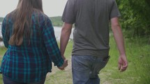 a couple walking holding hands 