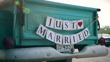 Just married on the back of an old truck 