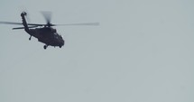 Three BlackHawk military helicopters flying in formation