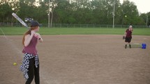 woman hitting a softball 