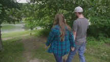a couple walking holding hands outdoors 