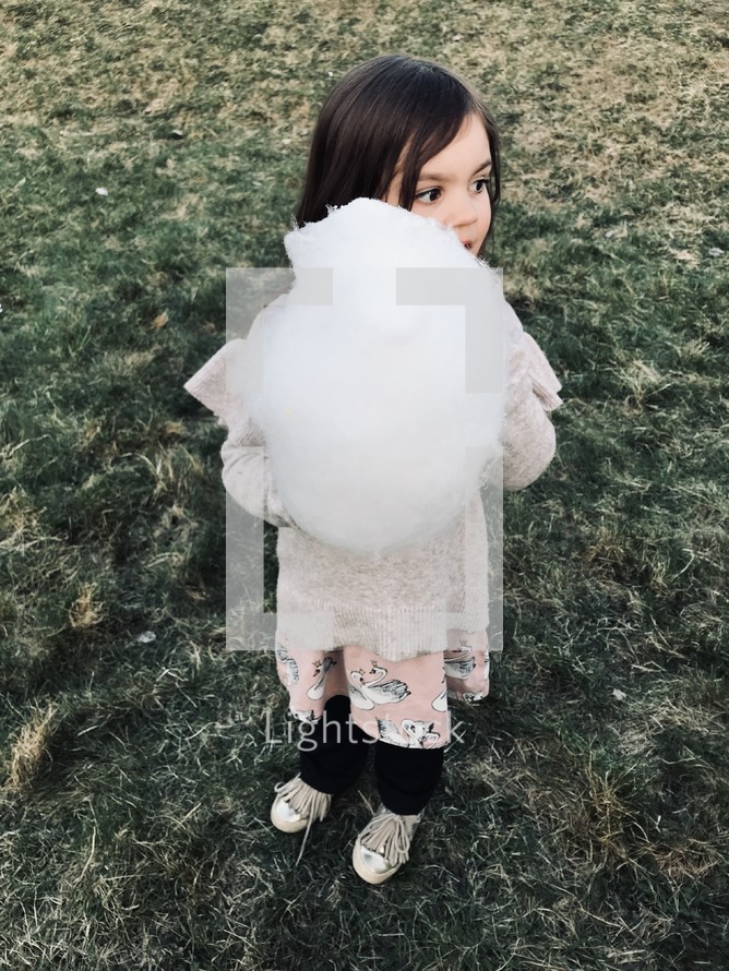 toddler girl with cotton candy 