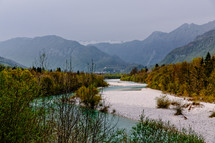 A river running through a valley amid mountains.