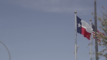 Texas and American flags on a Flagpole 