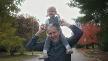 toddler on her grandfather's shoulders 