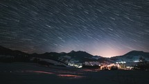 Star trails magic in beautiful winter night countryside, Starry sky comet effect Astronomy Time lapse Night to day

