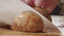 Chef Slicing Brown Portobello Mushroom. - close up shot