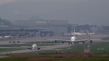 Airplanes taxiing on runway at airport