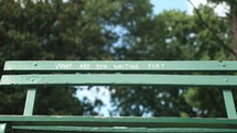 what are you waiting for written on a park bench 