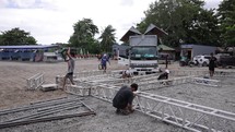 Asian Workers Setting Up Scaffolding