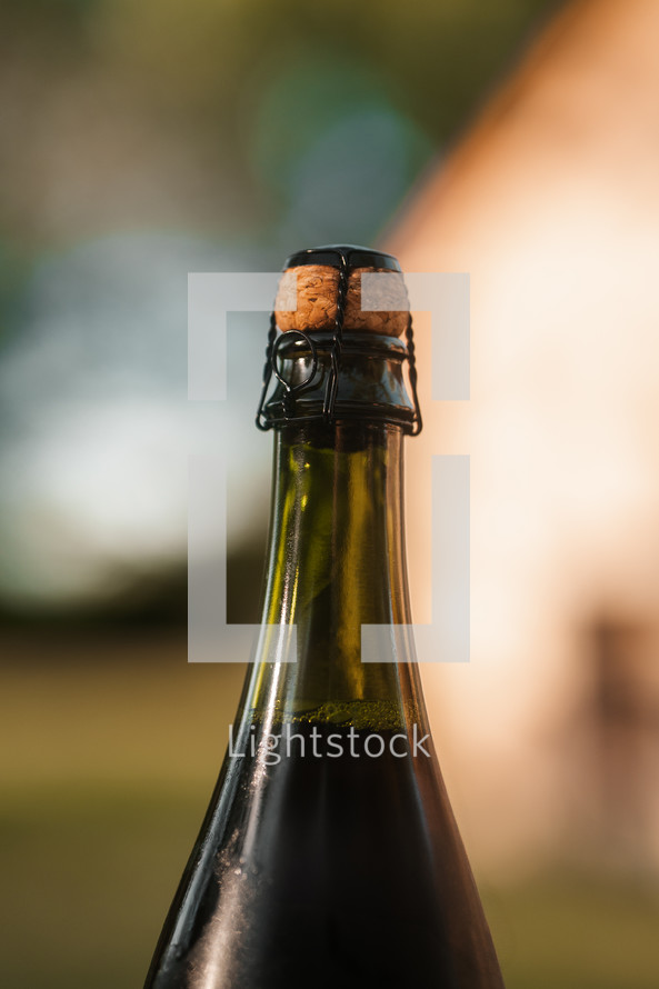 Wine bottle with cork, red wine in a green bottle