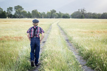 a boy walking in a field 