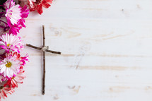 border of flowers and cross of sticks 