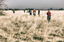 tourists exploring a field 