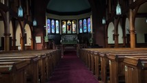 Walkthrough old church with pews and stain glass