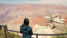 Grand Canyon, Arizona -  tourist woman hiking, standing on Grand Canyon mountain scenery.