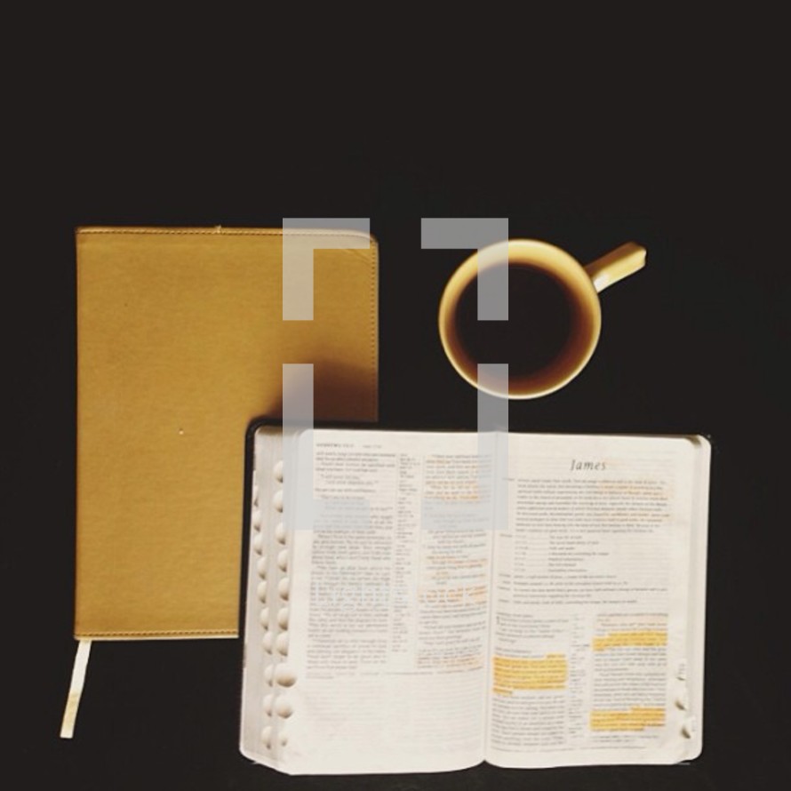 Two Bibles and a cup of coffee against a black background.
