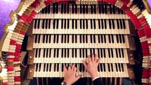 hands playing an organ 