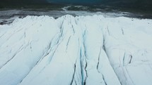 Flying Low Over Deep Cracks In A Glacier	