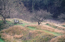 empty park bench on a countryside hill 