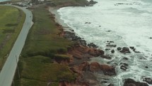 aerial view over a shoreline and lighthouse 