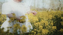toddler girl picking flowers 