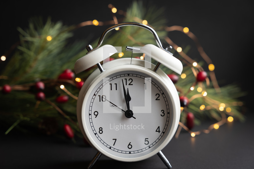 alarm clock and Christmas garland 