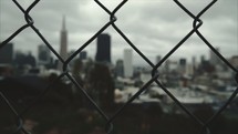 Looking through a fence at a city 