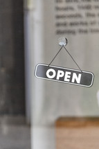 open sign on a window 