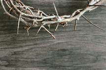 crown of thorns on dark wood background 