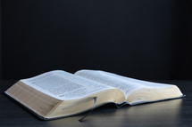 Open bible on a black background